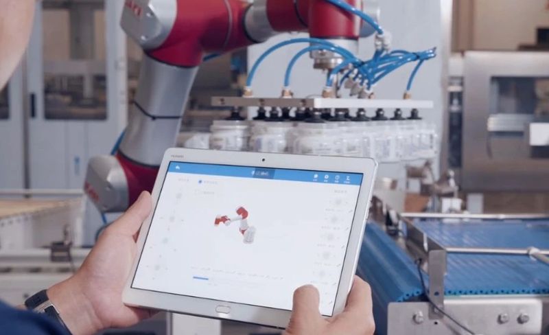 A user controlling the JAKA Pro series cobot from a tablet.