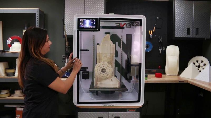 the woman prints on the EVO 22 Large 3D Printer/Additive Manufacturing Center