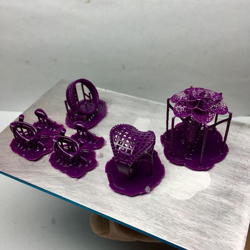 3d print is set of rings and earrings in purple resin