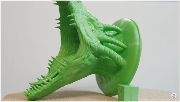 A green dragon is printed on the Artillery Genius 3D printer