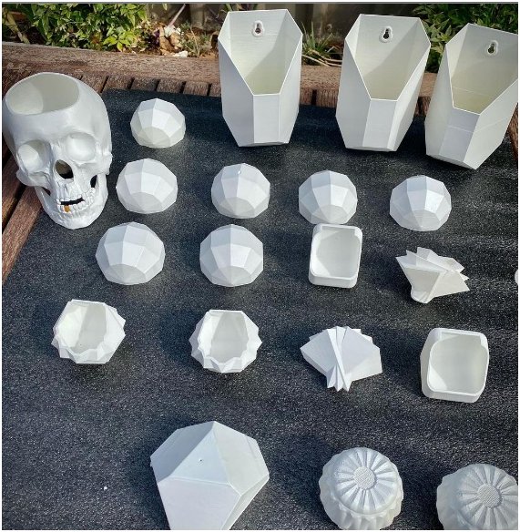 A white model skull and more details printed on the Creality CR-6 MAX 3D printer