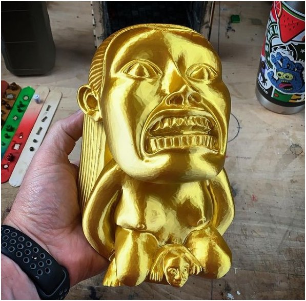 A gold human model printed on the Flashforge Adventurer 4 3D printer