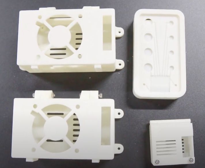 a white different models printed on the Zongheng3D SuperMaker SLA600