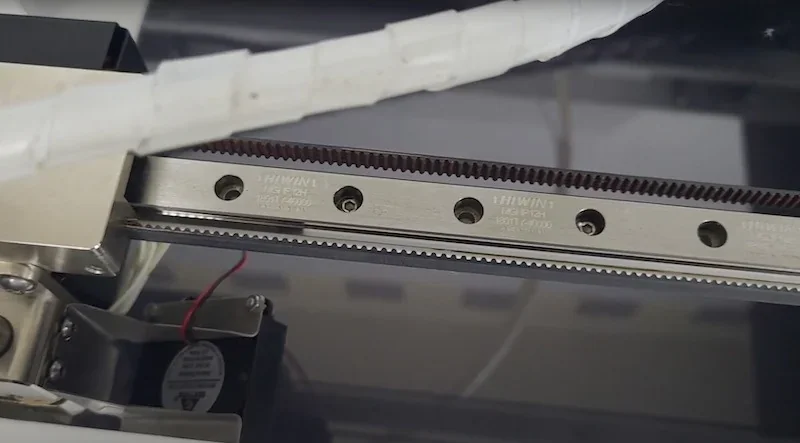 Anisoprint Composer A3 printer with detailed view of linear rail and motor components, showcasing precision engineering for 3D printed parts.