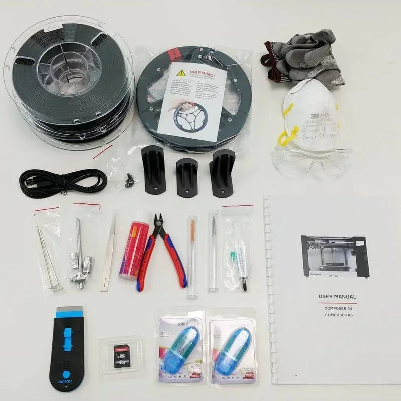 Anisoprint Composer A4 accessories: print filament spools, tools, safety gear, user manual, SD card, showcasing setup essentials.