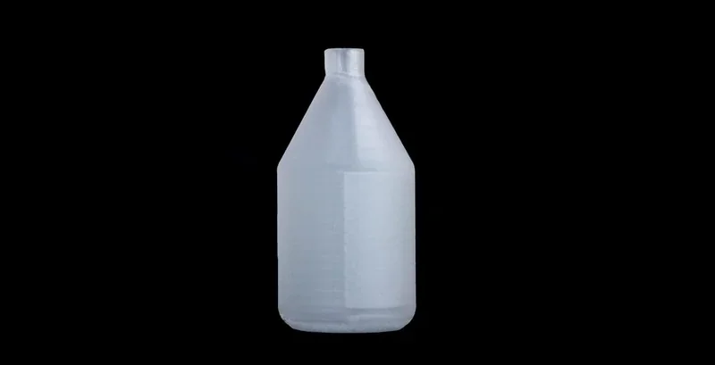 Translucent 3D printed bottle part created by Apium P400, displayed against a black background.