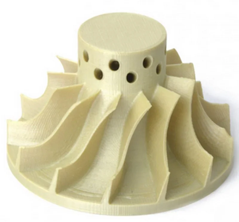 Apium P400 3D-printed beige turbine part with curved blades and circular holes.
