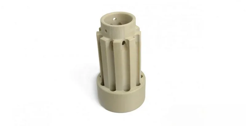Beige 3D-printed cylindrical part with vertical grooves, created by Apium P400, on a white background.