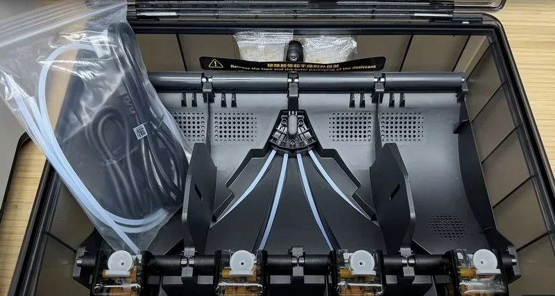 Bambu H2D 3D printer filament holder with cable and compartments, showcasing organized storage design.