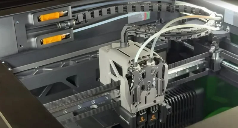 Bambu H2D 3D printer showcasing its internal components and filament tubes, highlighting precision engineering and advanced printing capabilities.