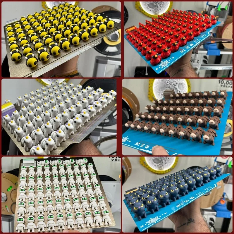 Bambu Lab H2D Pro prints multiple 3D figures: yellow faces, red birds, white animals, brown bears, robots with green eyes, and black cats in a workspace.