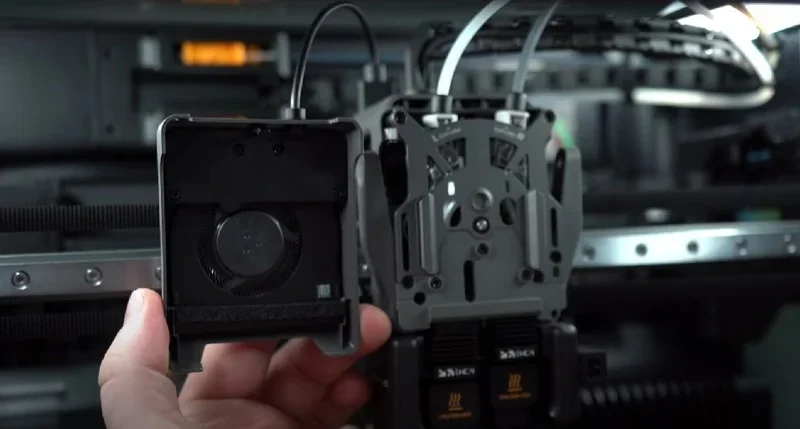 Bambu Lab H2D Pro 3D printer components with a cooling fan and filament tubes, showcasing intricate design and technology.