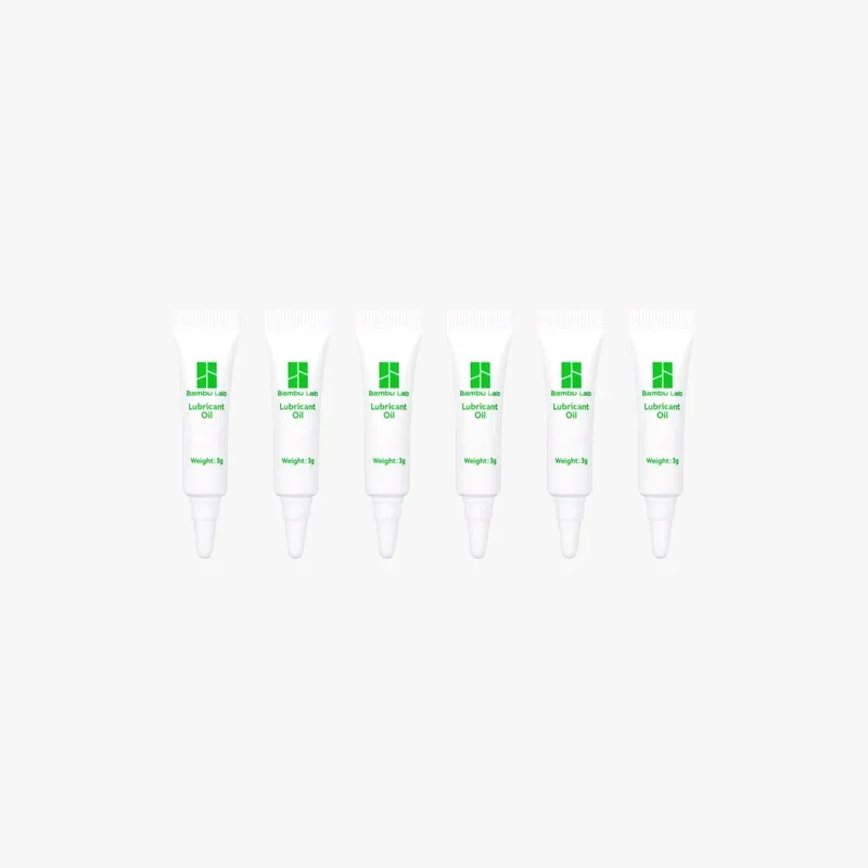 Six white Bambu Lab lubricant oil tubes, each labeled with brand logo and weight, arranged in a row against a plain background.