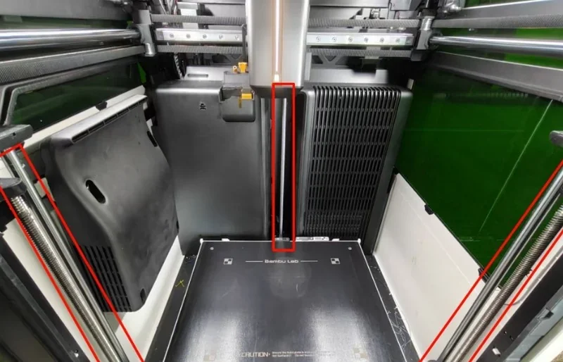 Bambu Lab H2S 3D printer interior showcasing build plate and mechanical components, highlighting precision engineering and potential printed parts.