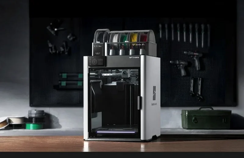 Bambu Lab H2S 3D printer with filament spools, set in a workshop with tools on the wall, used for creating various sample parts.
