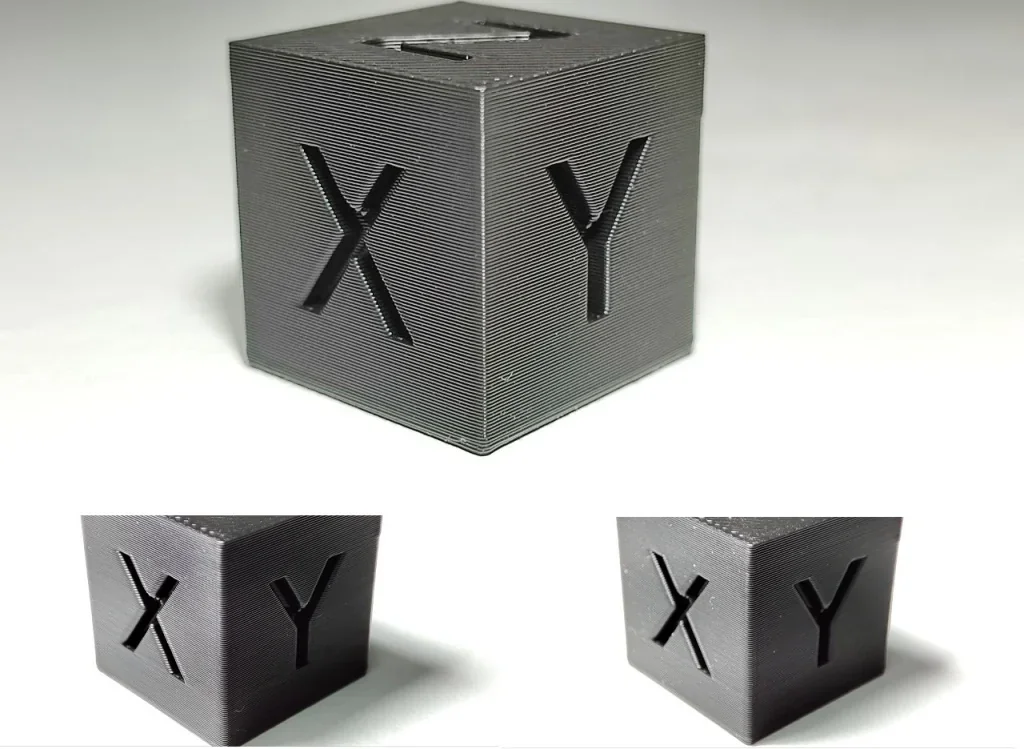 3D-printed black cube displaying "X" and "Y" letters, created by Bambu Lab X1, demonstrating precise detail and smooth surface texture.