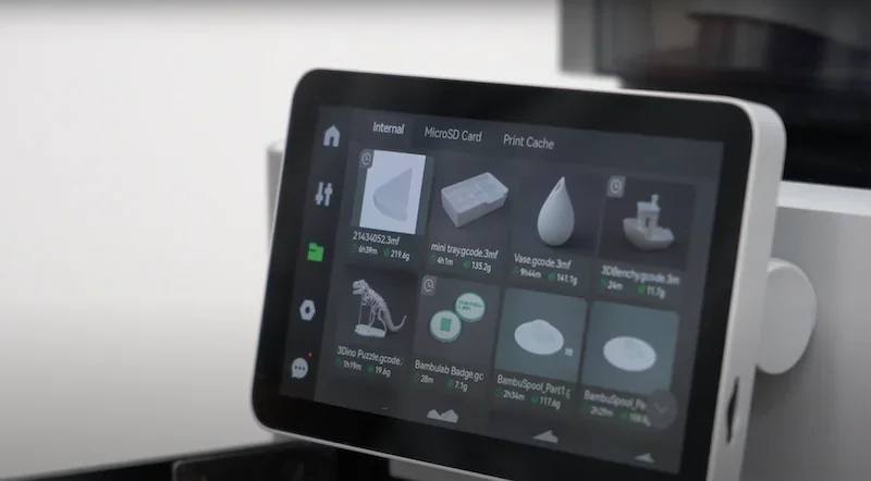 Bambu Lab X1 3D printer display showing digital models of parts like a dinosaur puzzle and vase, ready for printing.
