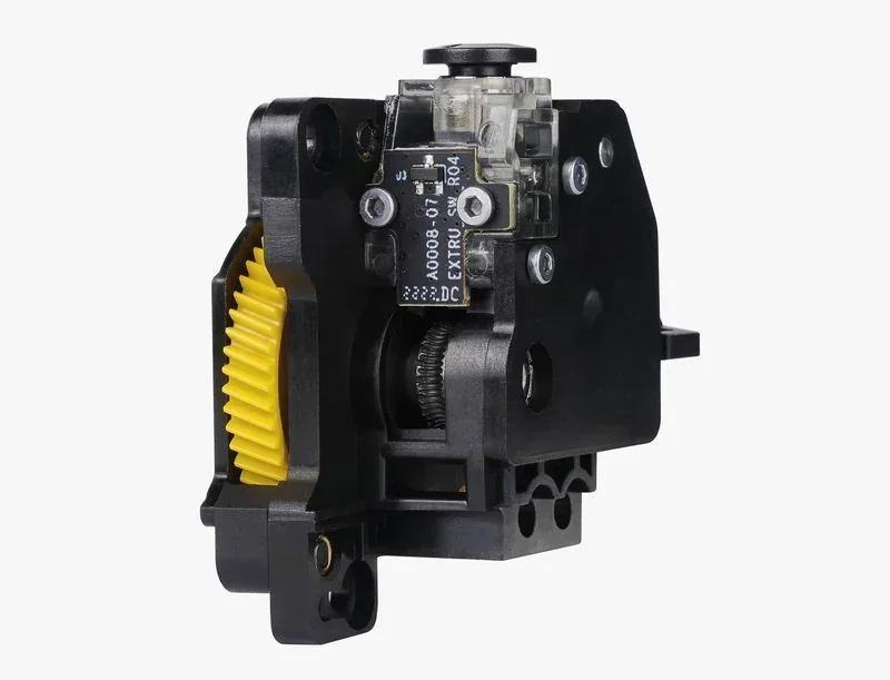 Bambu Lab X1 extruder component with black casing, visible yellow gear, and circuitry detailing.