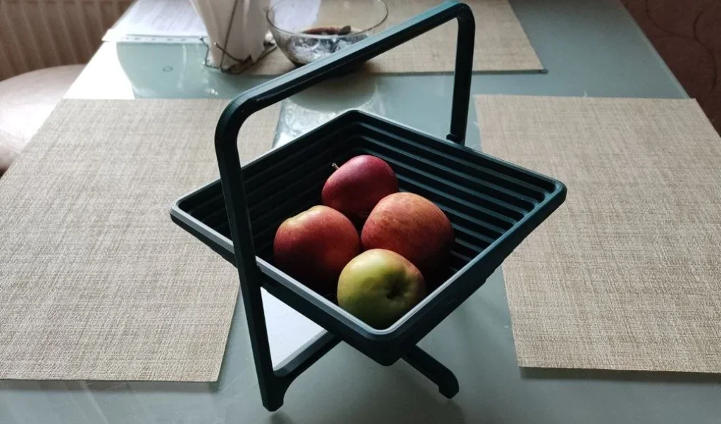 3D-printed basket with apples on a table, created by Bambu Lab X1.