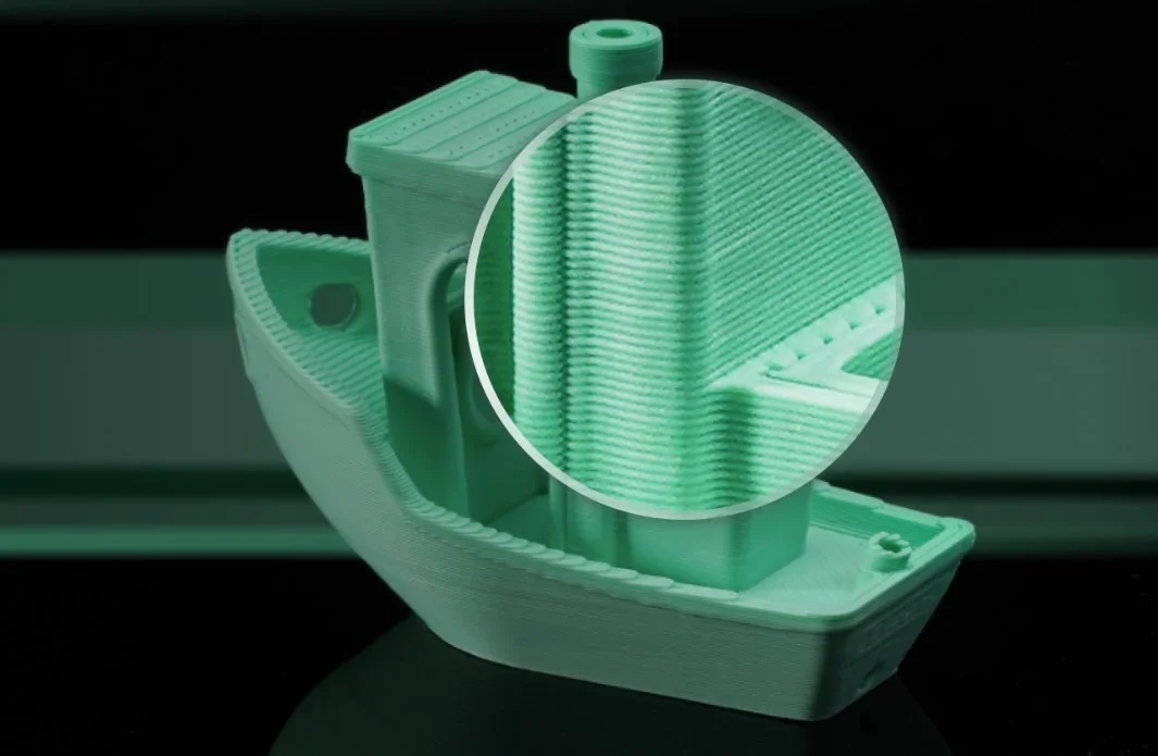 3D printed green boat model with detailed layer view, showcasing precision of Bambu P1P printer.