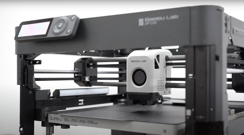 Bambu Lab P1P 3D printer in operation, showcasing the extruder mechanism and branding, producing precise components.