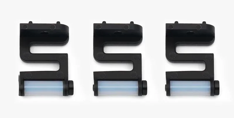 Three identical black 3D-printed brackets with cylindrical rollers, created by the Bambu P1P printer, displayed against a plain background.