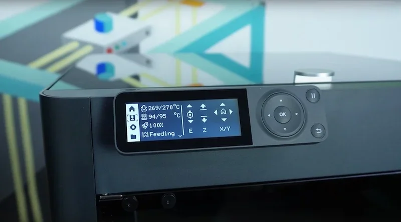 Bambu P1S 3D printer control panel close-up, displaying temperature and settings against a colorful geometric backdrop.