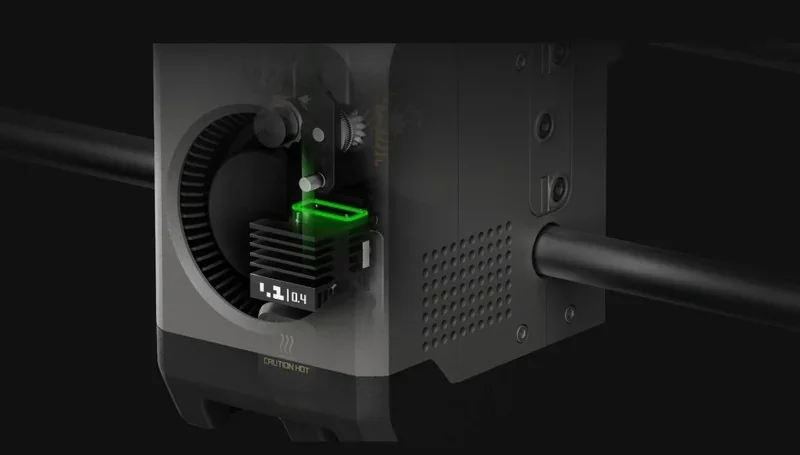 Bambu P2S 3D printer extruder close-up, featuring a green-lit area and detailed internal components indicating precision engineering.