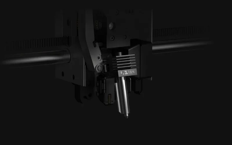 Bambu P2S 3D printer nozzle assembly with sleek black design, precise mechanics visible, showcasing cutting-edge technology for 3D printing.