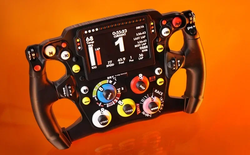 Bambu P2S-created racing wheel with multiple buttons and dials on bright orange background, highlighting detailed craftsmanship and technology.
