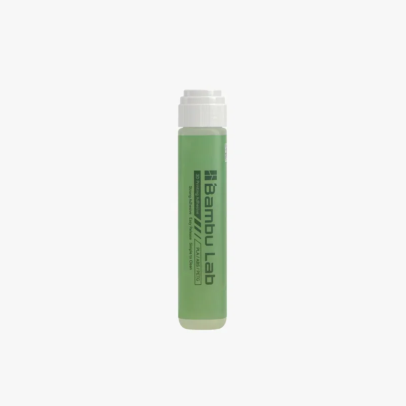 Bambu Lab 3D printer adhesive in a green tube, labeled "PLA/ABS/PC/PETG," for strong adhesion on Bambu P2S prints, white cap.