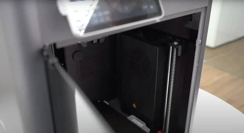 Bambu X1E 3D printer interior, showcasing its build area, with visible components for creating precise samples and parts.