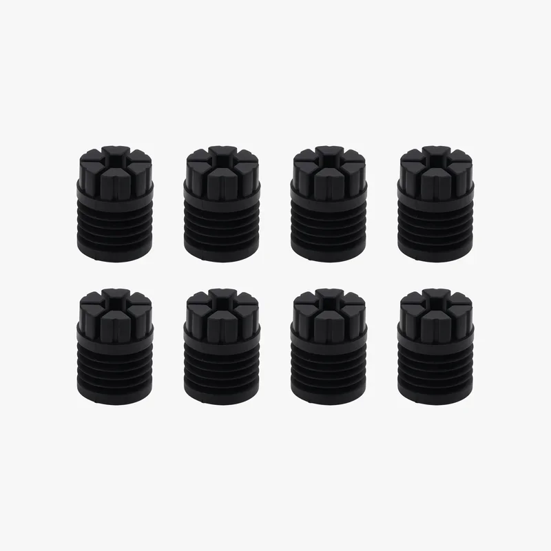 Eight black cylindrical parts with ridged sides, likely 3D printed by the Bambu X1E, arranged in two rows on a light background.