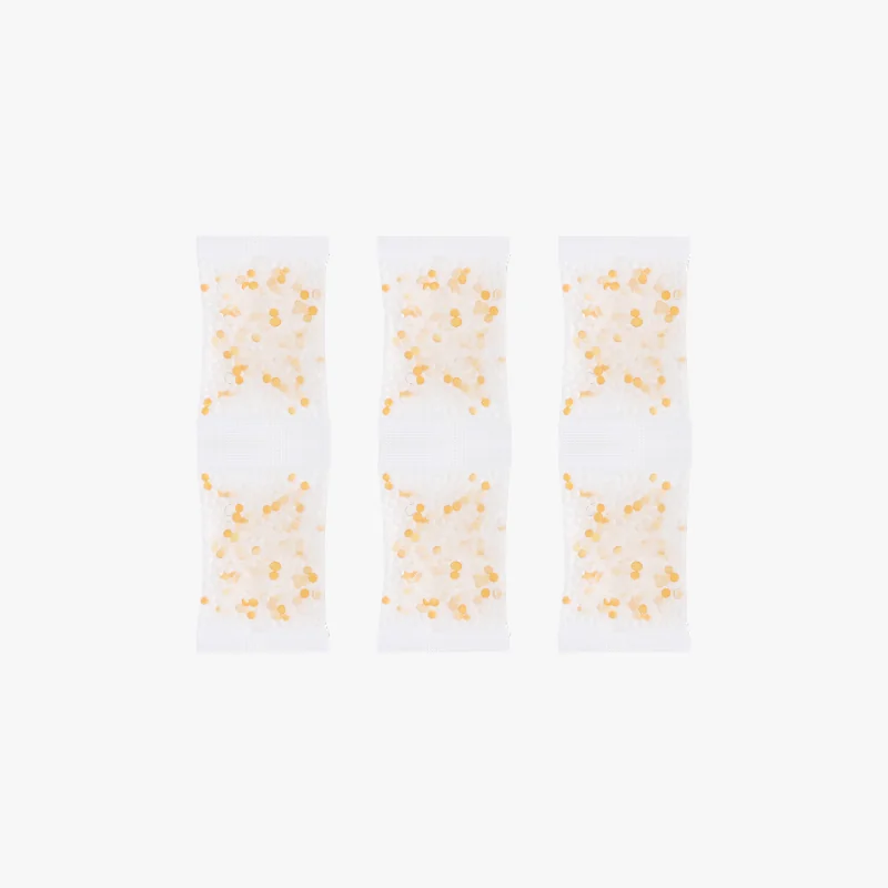 Translucent packets with orange dots, possibly filtration beads, on a white background. Created by Bambu X1E 3D printer.