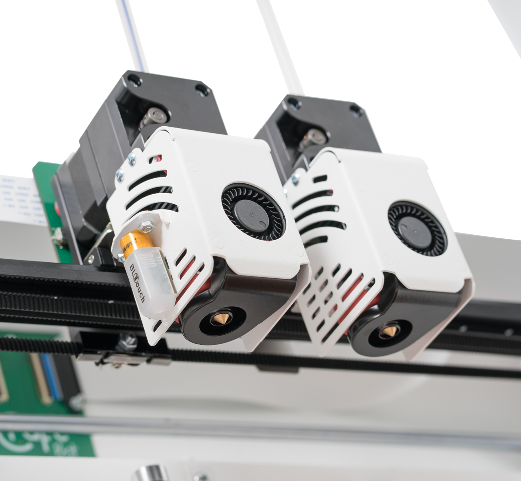 Craftbot Flow IDEX XL 3D printer dual print heads close-up, featuring cooling fans and precision nozzles on a sleek rail system.
