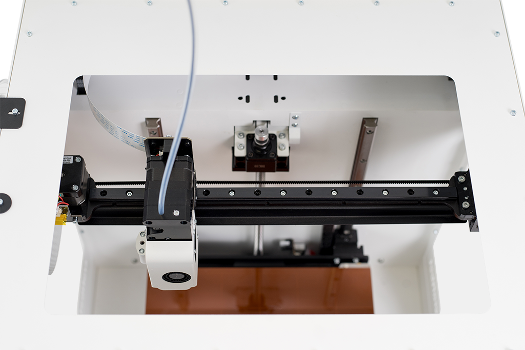 Craftbot Flow IDEX XL 3D printer interior, featuring dual extruder rails and a clear view of mechanics, designed for precise filament printing tasks.