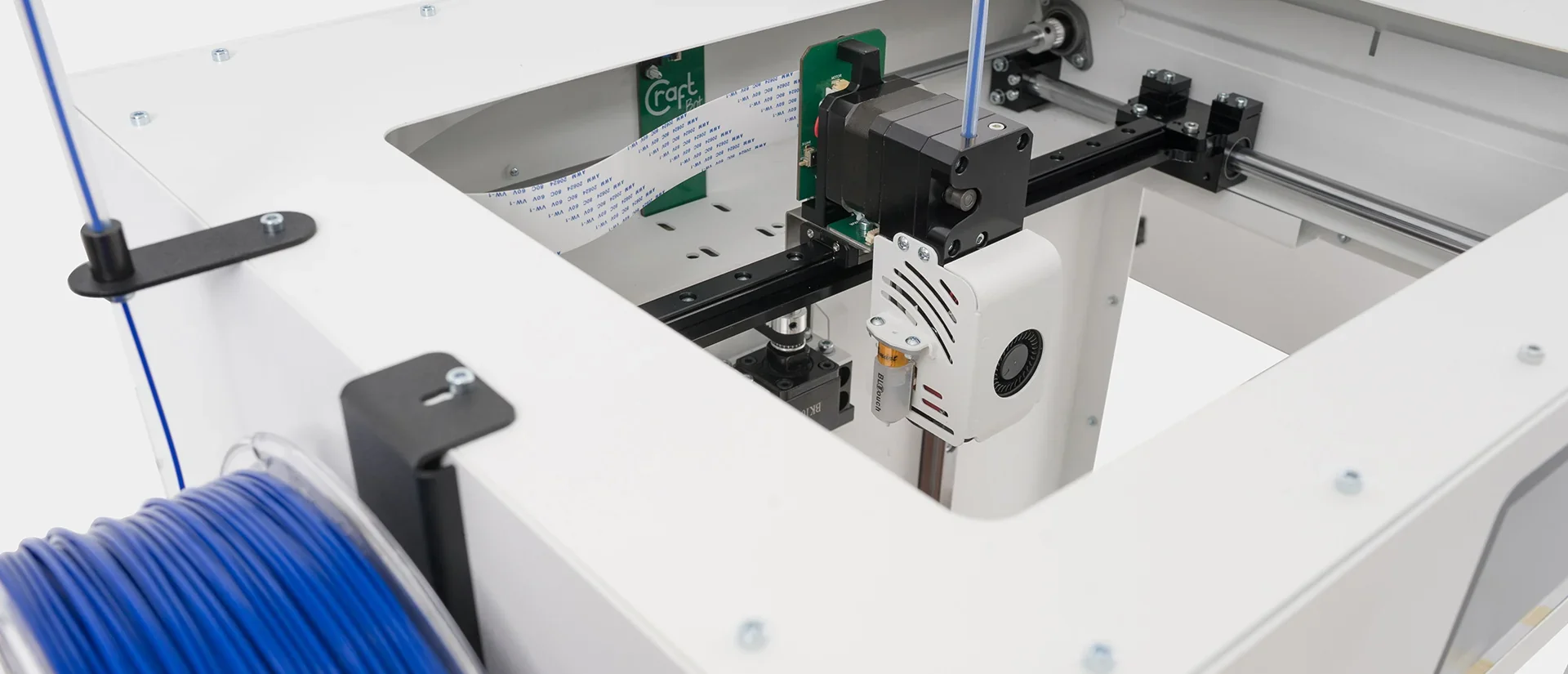 Craftbot Flow IDEX XL 3D printer interior showing dual extruder mechanism and filament spool, designed for precise, large-scale 3D printing.