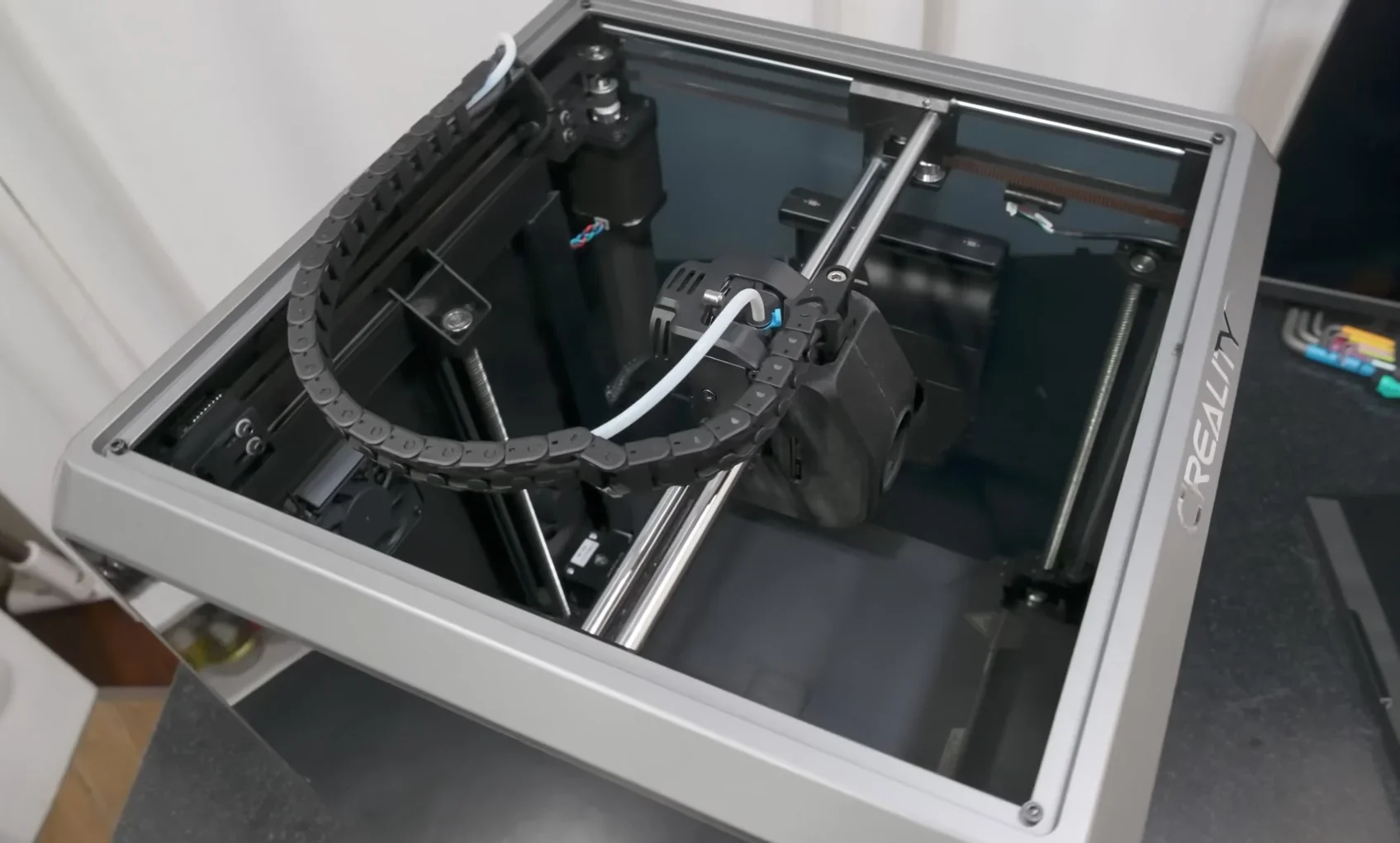 Creality K1 3D printer internal view showing mechanical components and branding, suitable for creating precise prints.