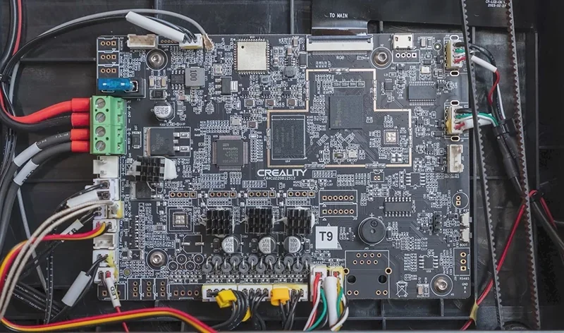 Creality K1 3D printer motherboard with wiring, displaying complex circuitry and Creality branding, essential for high-quality 3D printing operations.