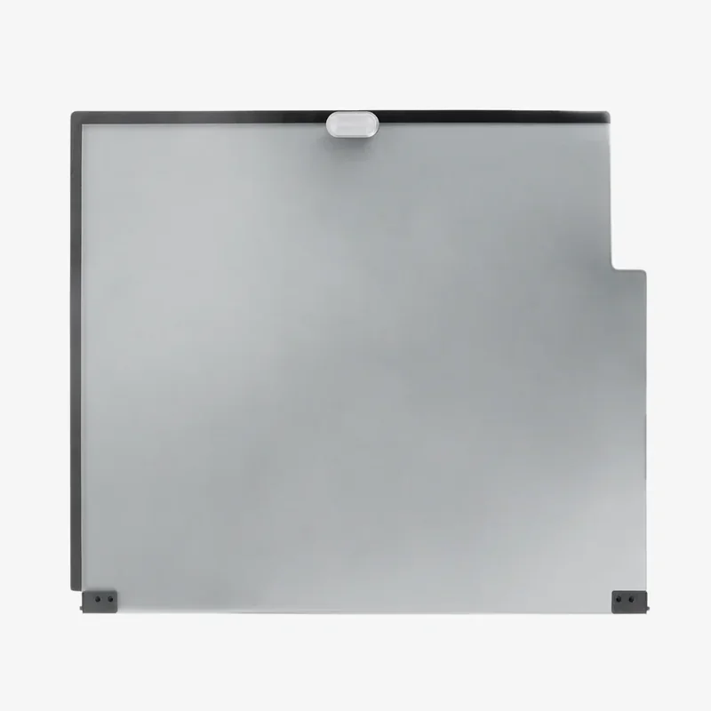 Creality K1 printer glass build plate with a gray tint, black frame, and clips, used for precise 3D printing, showcasing part of the printer bed.