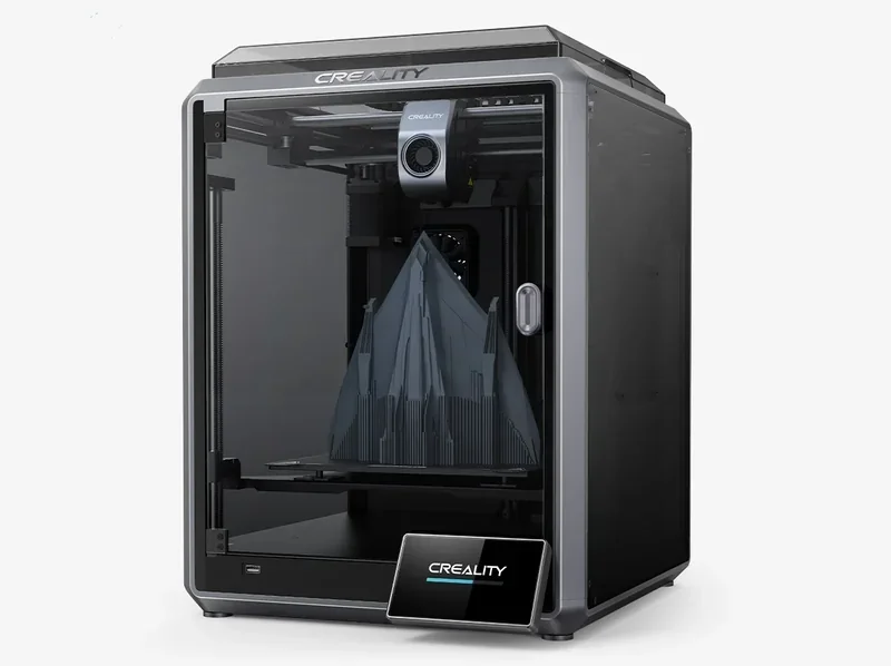 Creality K1 3D printer with transparent door showing a complex triangular model. Branding visible on top and front.