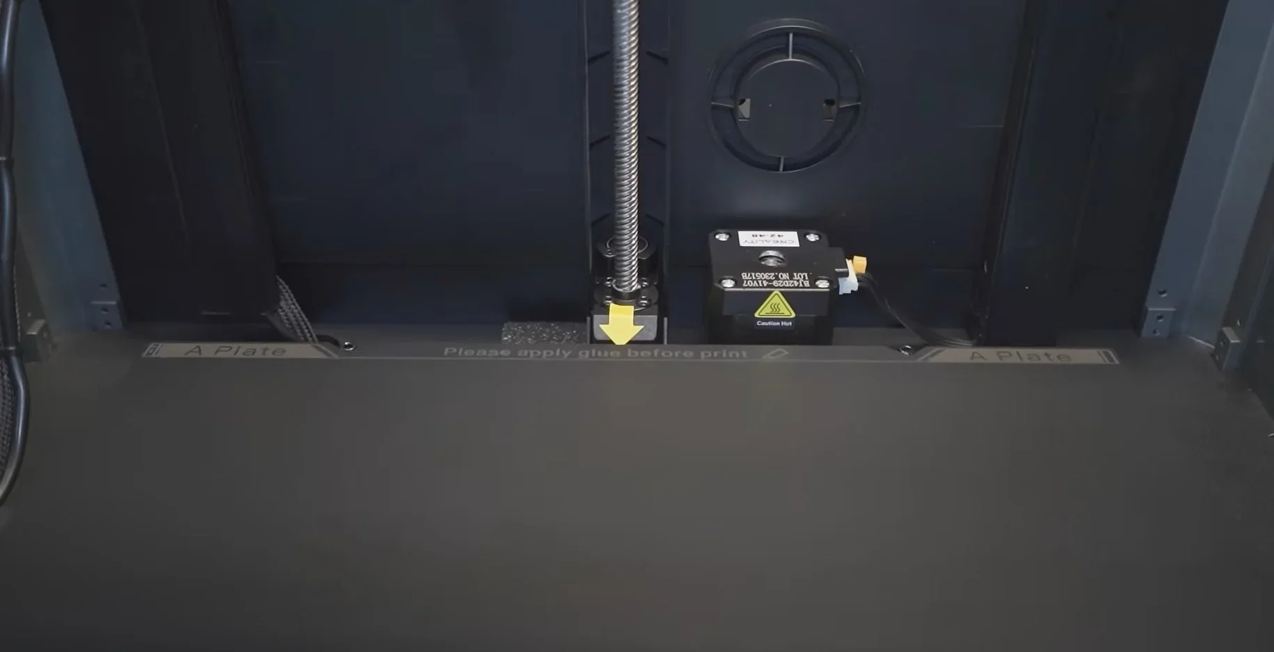 Creality K1 Max 3D printer with print bed, wiring, and caution signs, emphasizing precise printing setup and essential components.