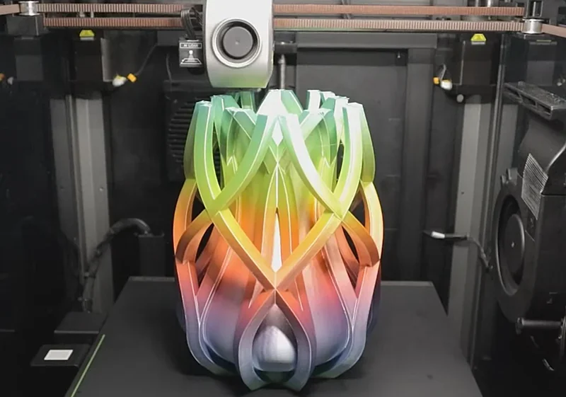 Creality K1 Max 3D printer creating a multicolored, intricate vase-like structure within its build chamber.