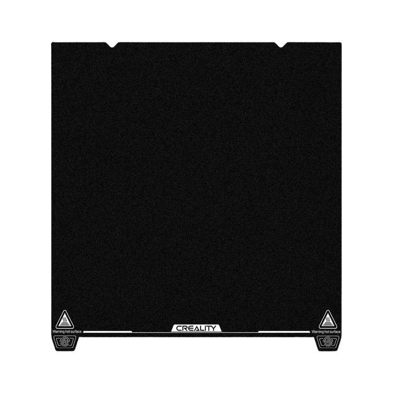 Creality K1 Max glass bed with black textured surface, Creality branding at bottom center, featuring warning signs in corners.