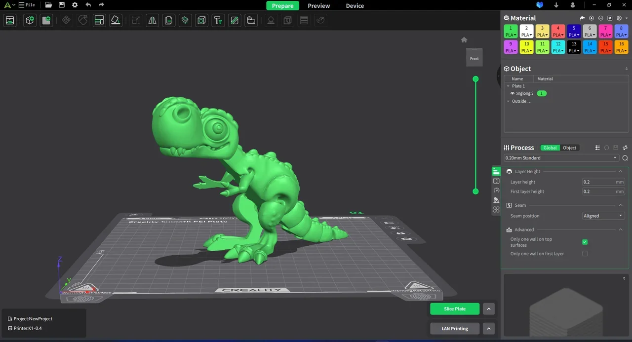 Creality K2 3D printer interface showing a green dinosaur model ready for printing on the virtual bed, with design options and settings visible.