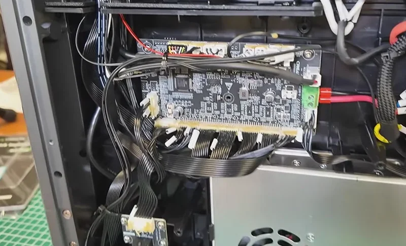 Creality K2 3D printer interior showing wiring and circuit board, highlighting technical components essential for printing operations.