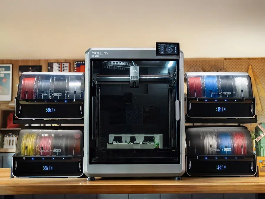 Creality K2 3D printer with five filament modules in various colors, placed on a wooden table, displaying efficient, compact, and sleek design.