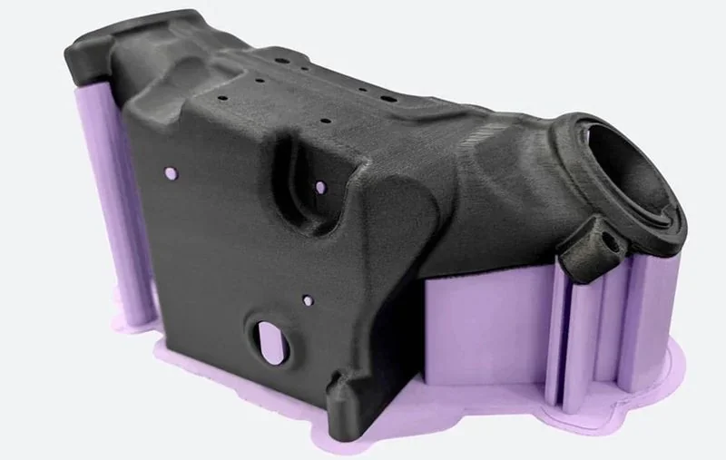 Black 3D-printed component created by CreatBot D1000, highlighting intricate design and purple supports, showcasing industrial printing capabilities.