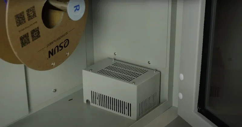 CreatBot D1000 3D printer internal view showing filament spool and electronic components, highlighting robust industrial design.