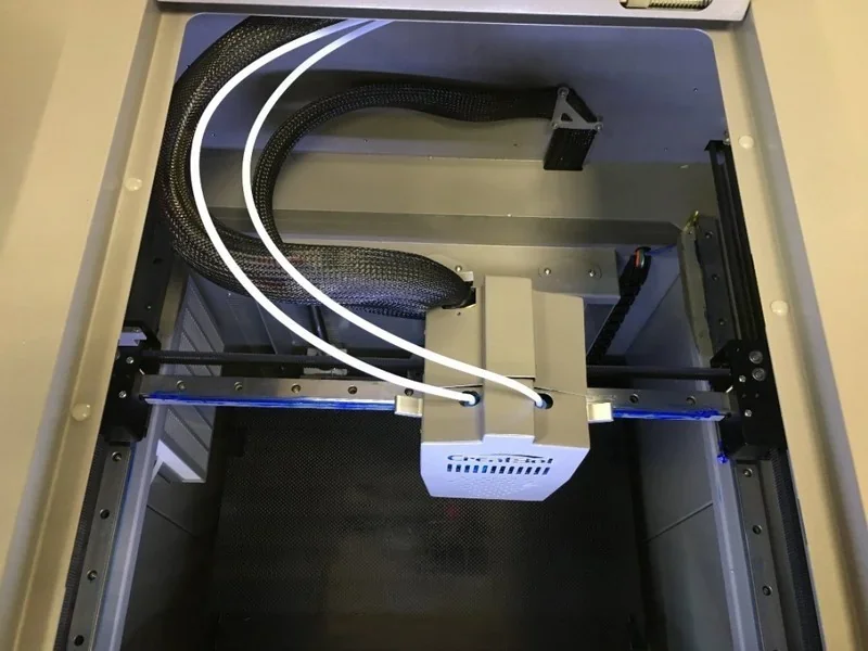 Creatbot D1000 industrial 3D printer interior view with print heads and cable setup, designed for large-scale, professional prototyping tasks.
